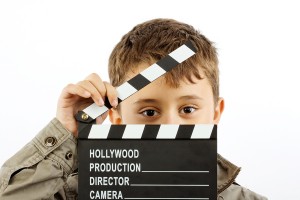 Boy with movie clapper board